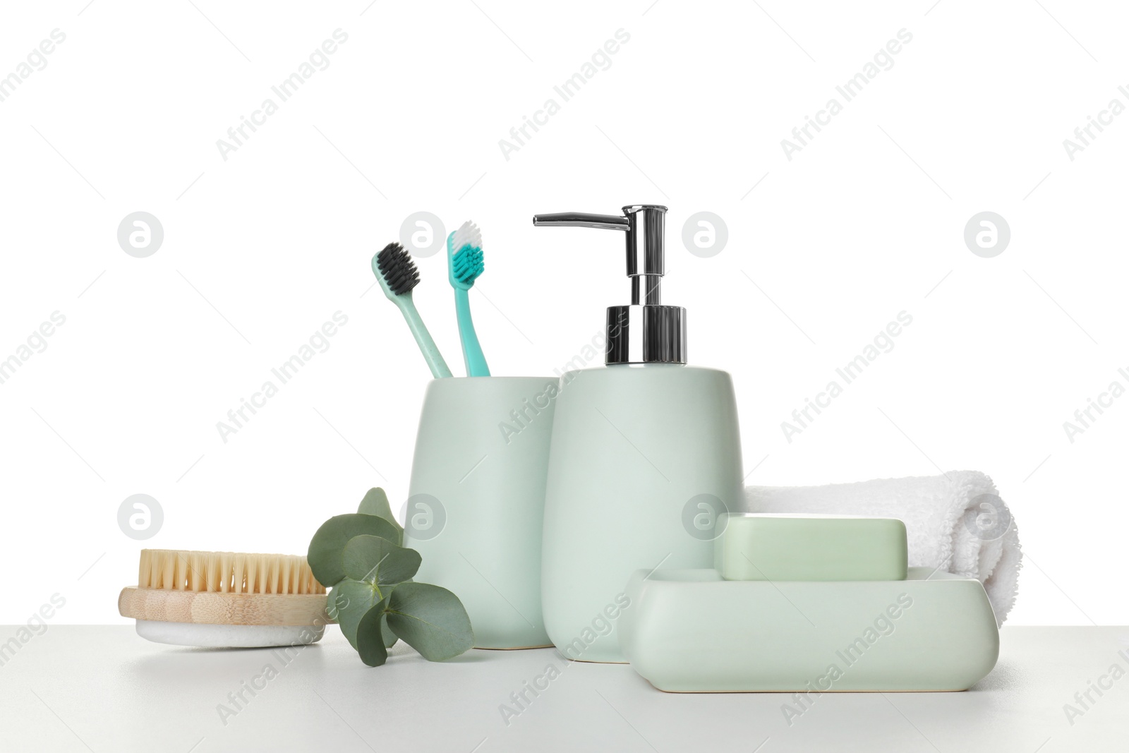 Photo of Bath accessories. Different personal care products and eucalyptus branch on table against white background