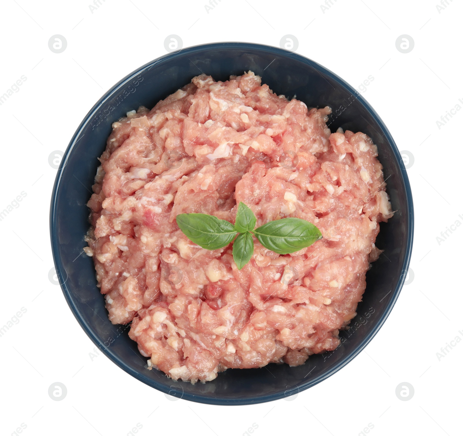 Photo of Raw chicken minced meat with basil in bowl on white background, top view