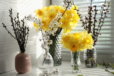 Yellow daffodils and beautiful branches on windowsill