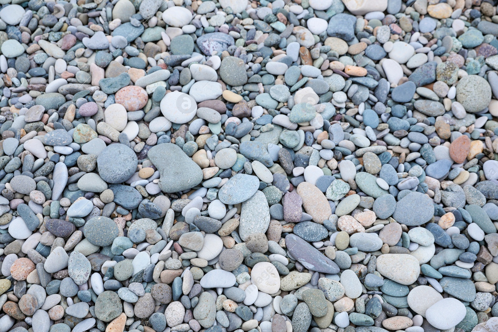 Photo of Surface covered with many different pebbles as background