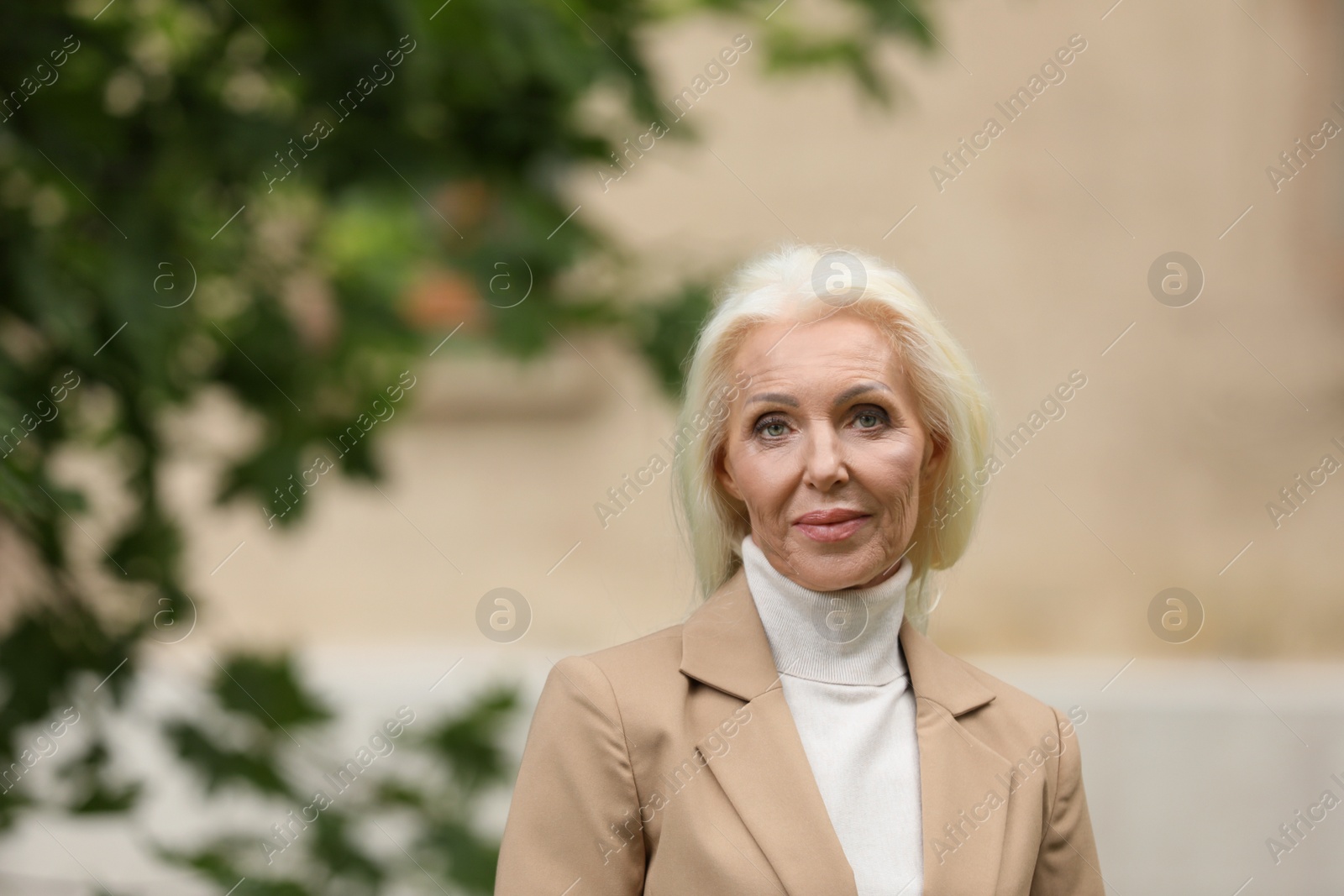 Photo of Portrait of elegant mature woman on city street