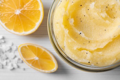 Photo of Body scrub in glass jar, sea salt on white wooden table, flat lay