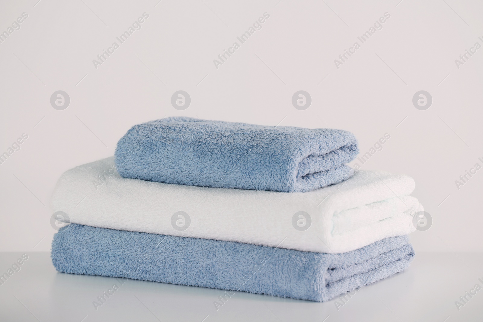 Photo of Stack of folded towels on white table