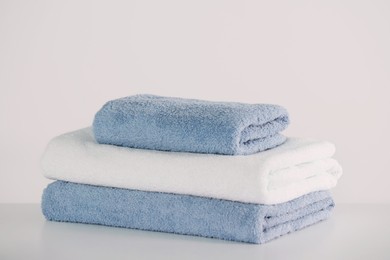 Stack of folded towels on white table