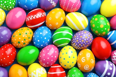 Photo of Many decorated Easter eggs as background, top view. Festive tradition