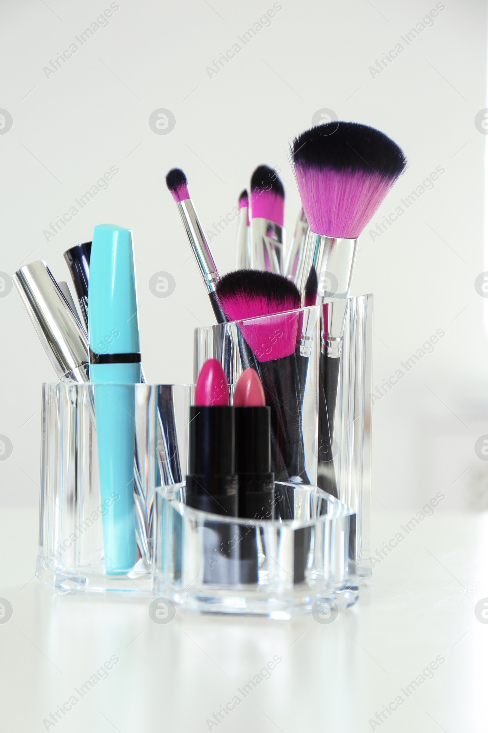 Photo of Organizer with cosmetic products for makeup on table indoors