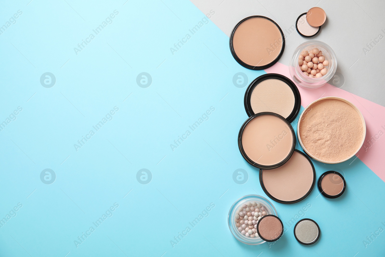 Photo of Flat lay composition with various makeup face powders on color background. Space for text