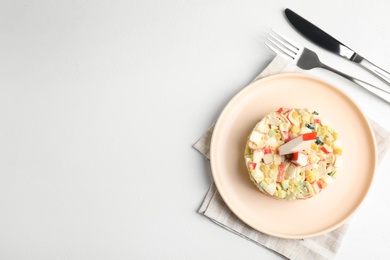 Photo of Delicious salad with fresh crab sticks on white table, flat lay. Space for text