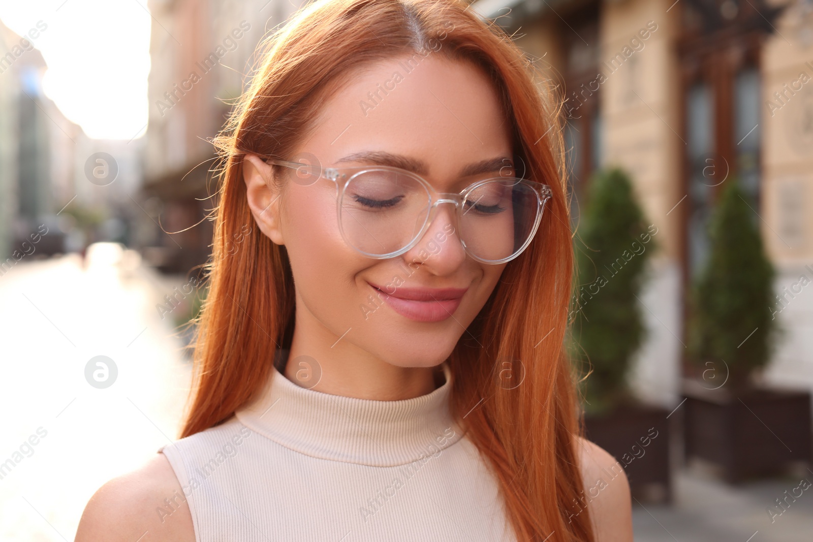 Photo of Portrait of beautiful woman in glasses outdoors