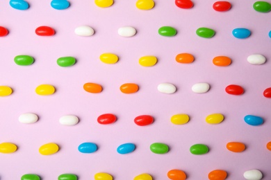 Photo of Flat lay composition with jelly beans on color background