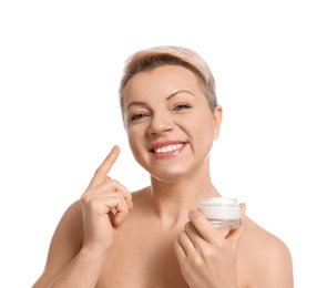 Photo of Mature woman with jar of face cream on white background