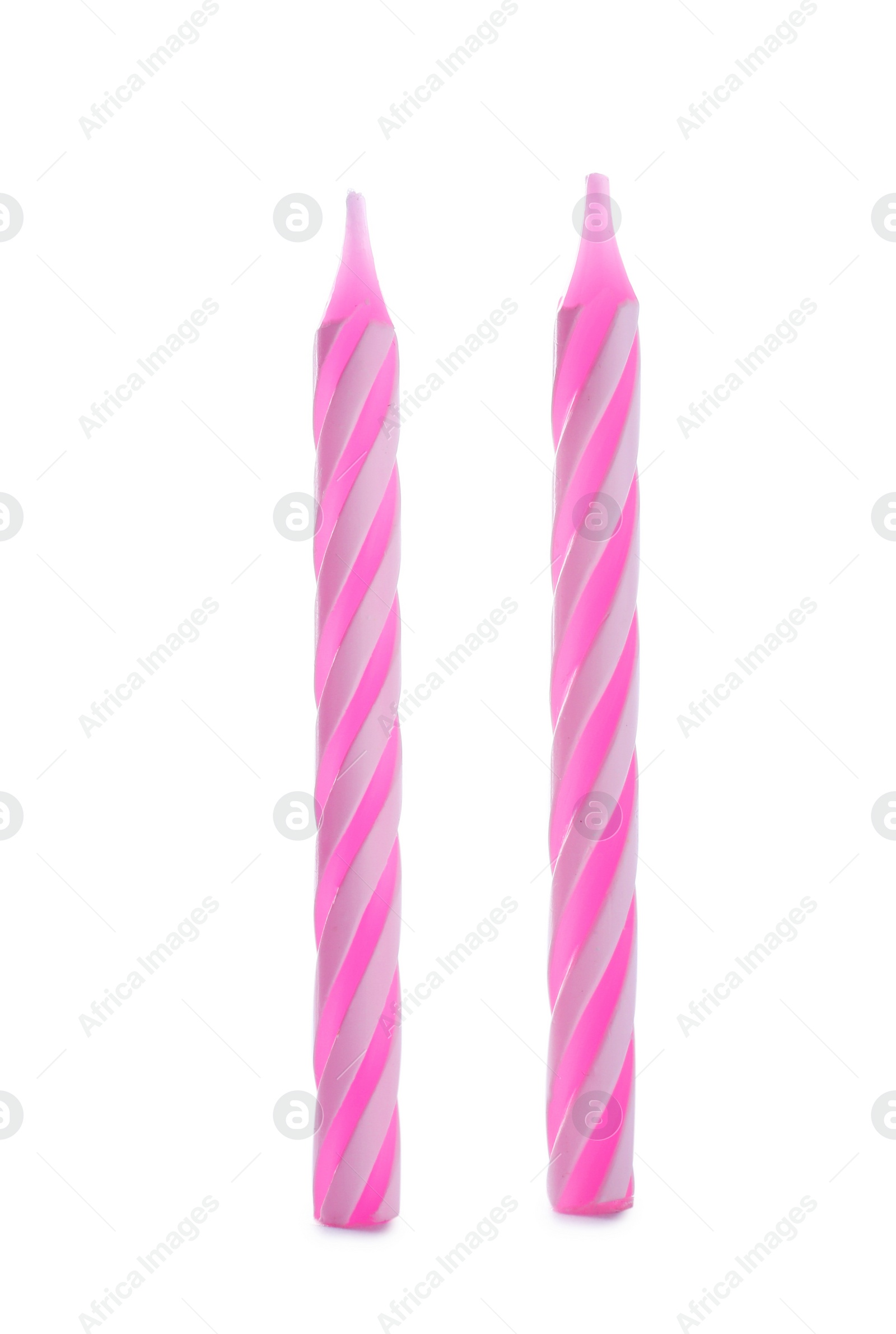 Photo of Pink striped birthday candles isolated on white