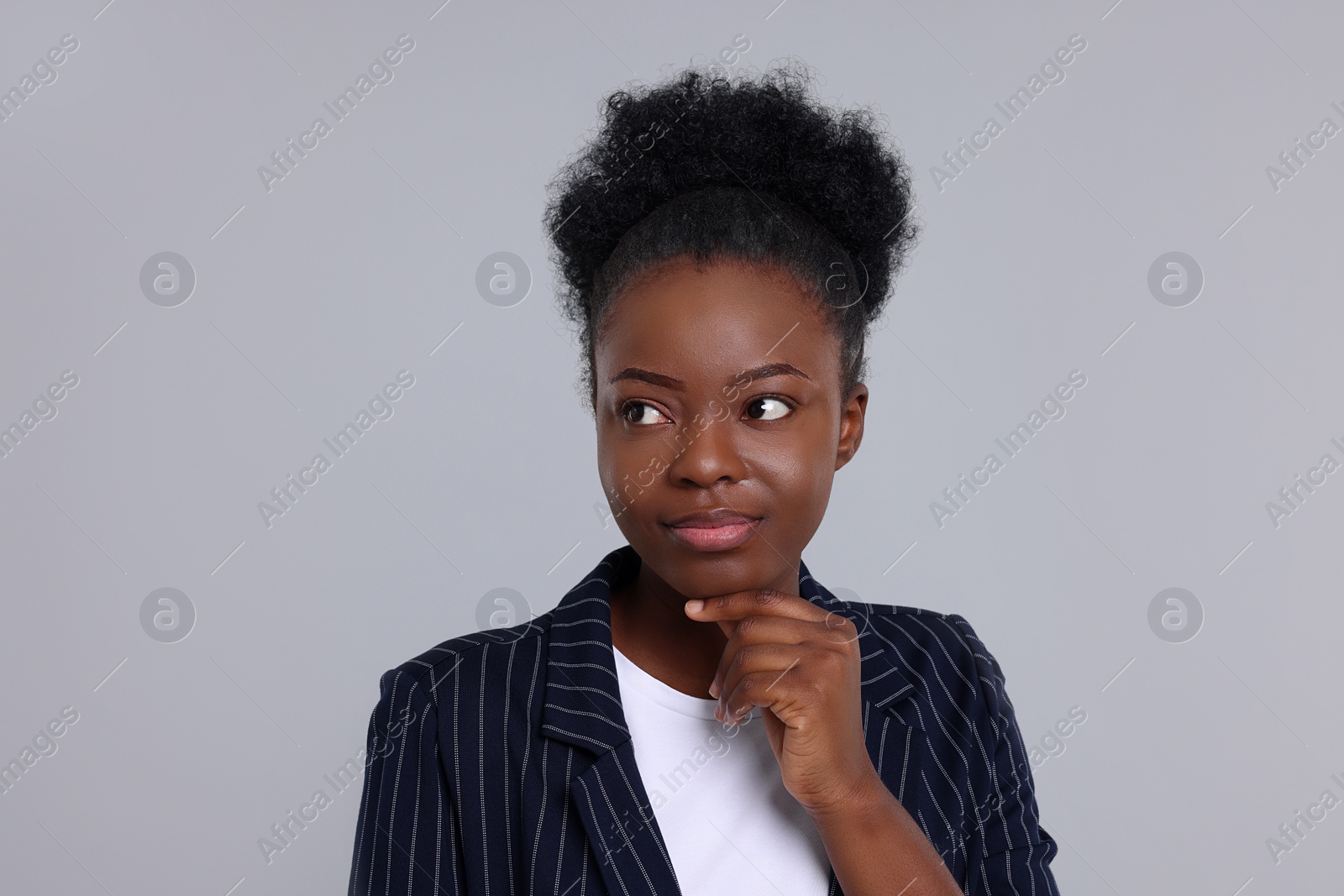 Photo of Portrait of beautiful young woman on light grey background