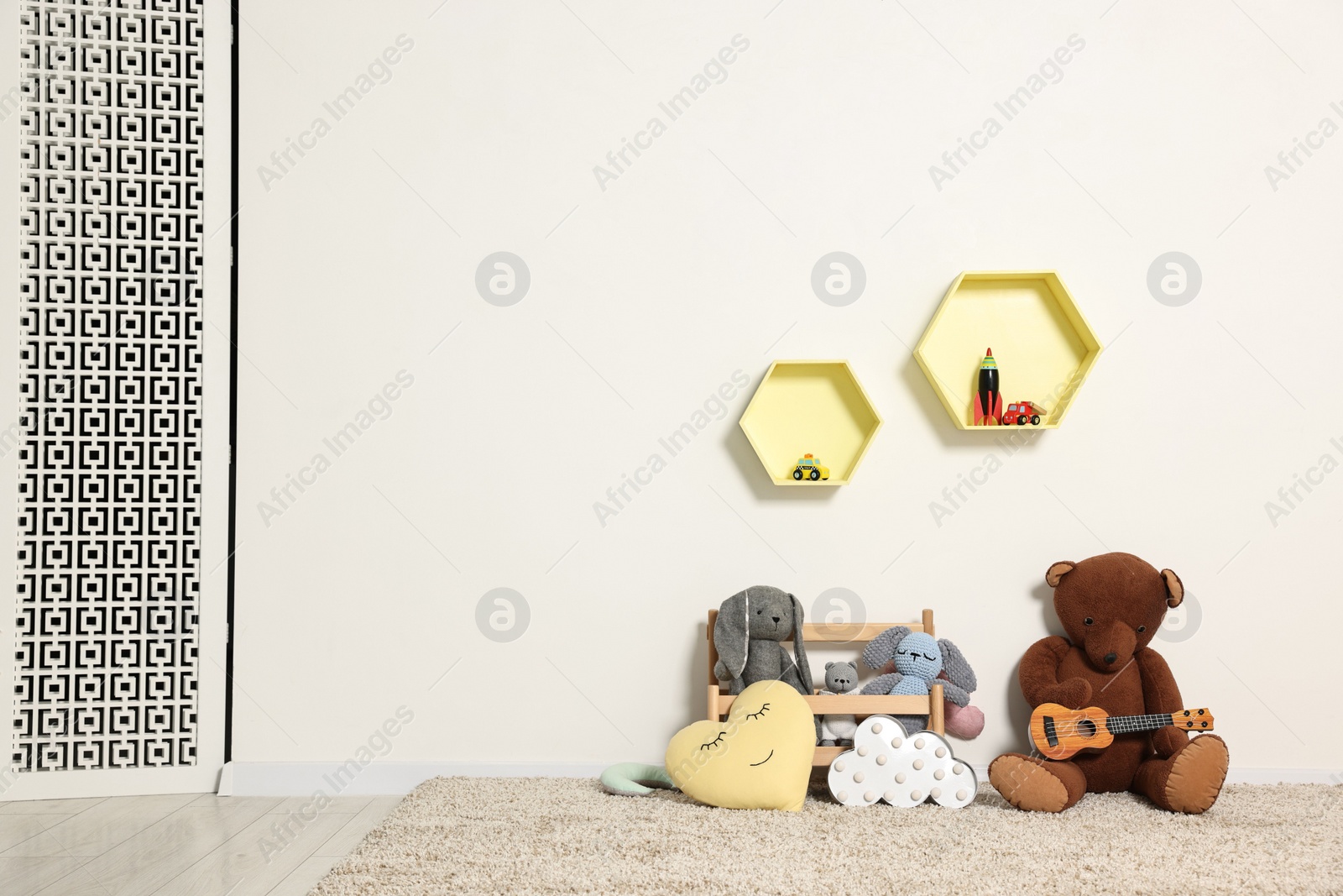 Photo of Soft toys and shelfs in beautiful children's room