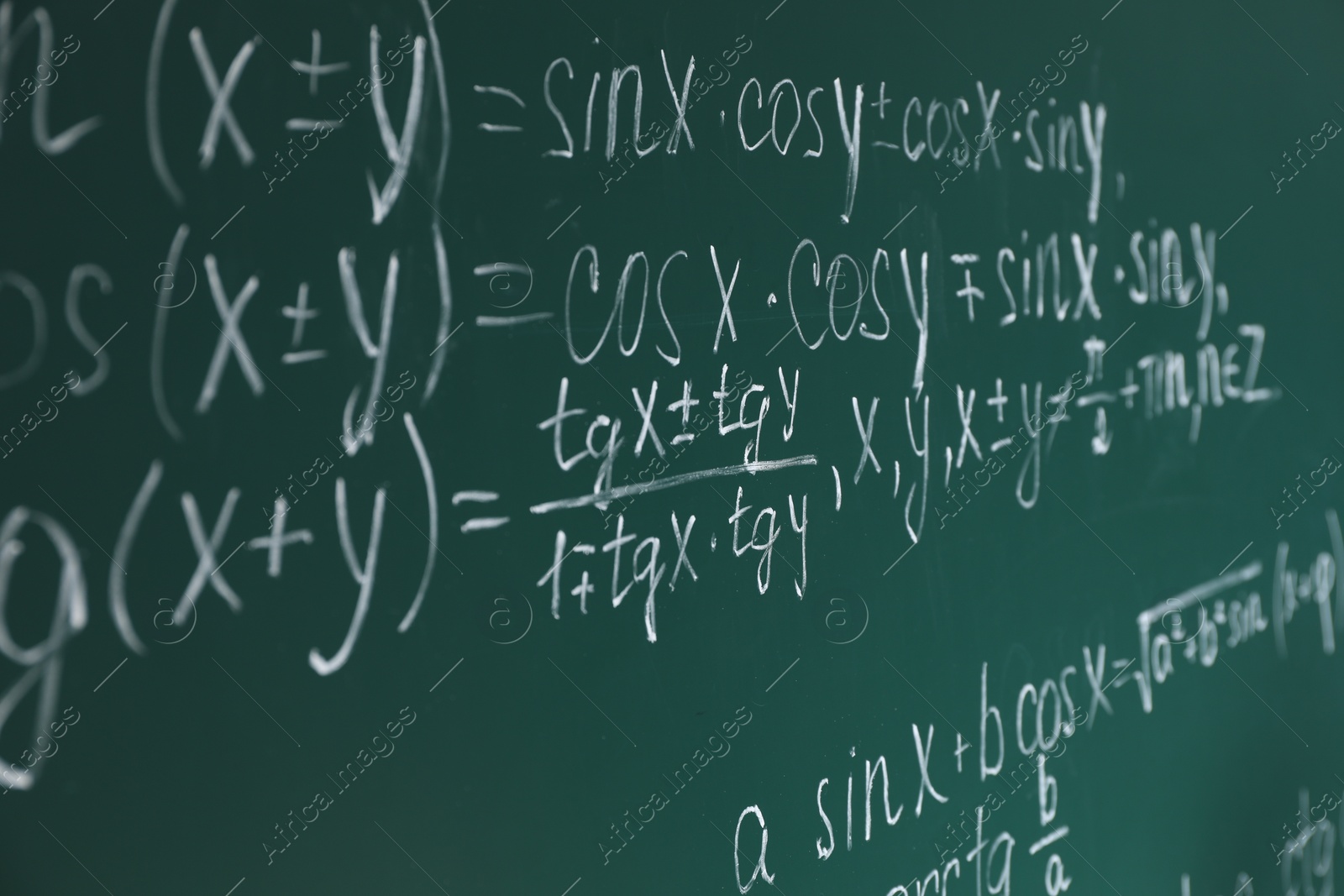 Photo of Many different math formulas written on chalkboard
