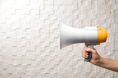 Photo of Woman holding megaphone on white background