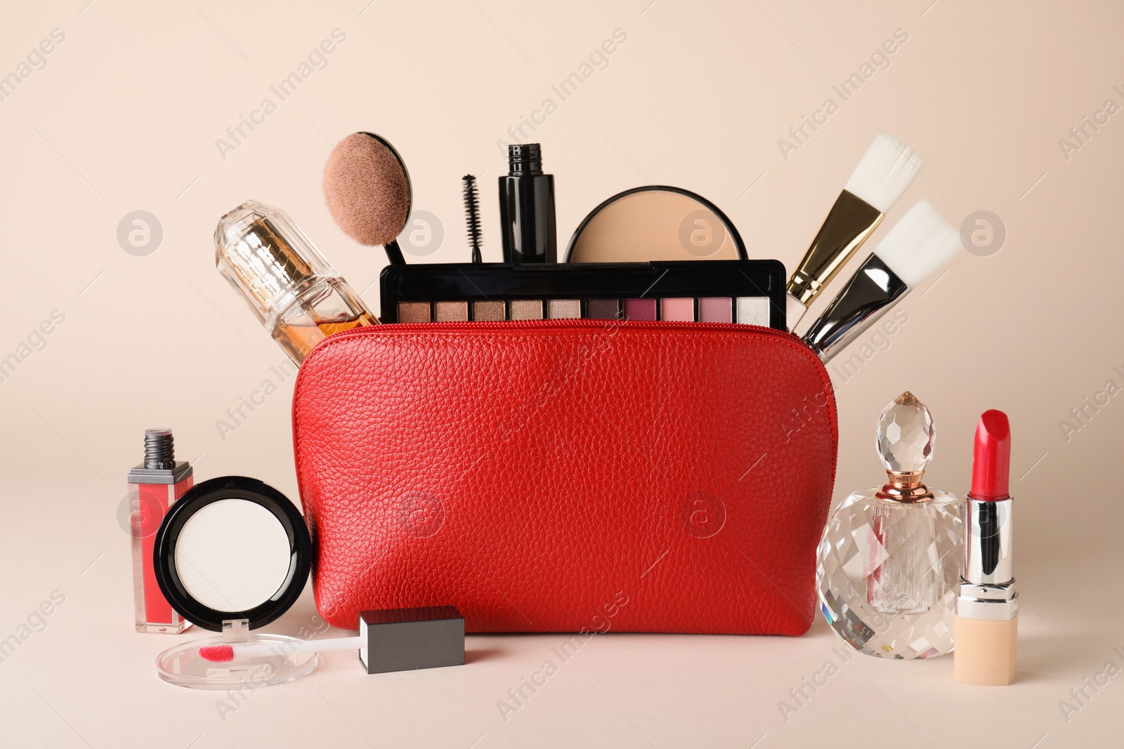 Photo of Cosmetic bag and makeup products with accessories on beige background