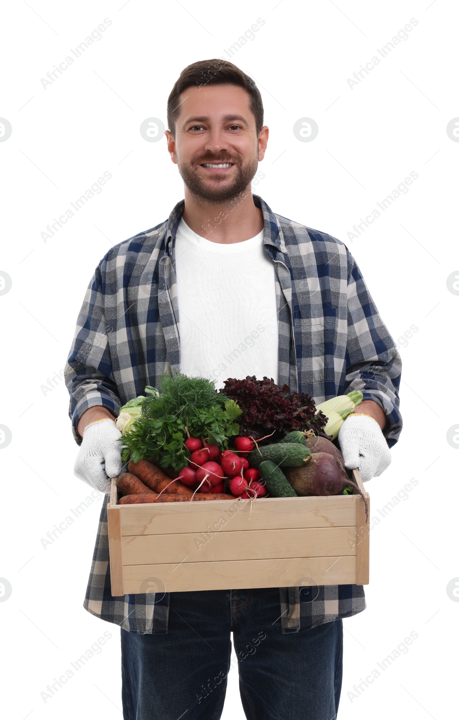 Photo of Harvesting season. Happy farmer holding wooden crate with vegetables on white background