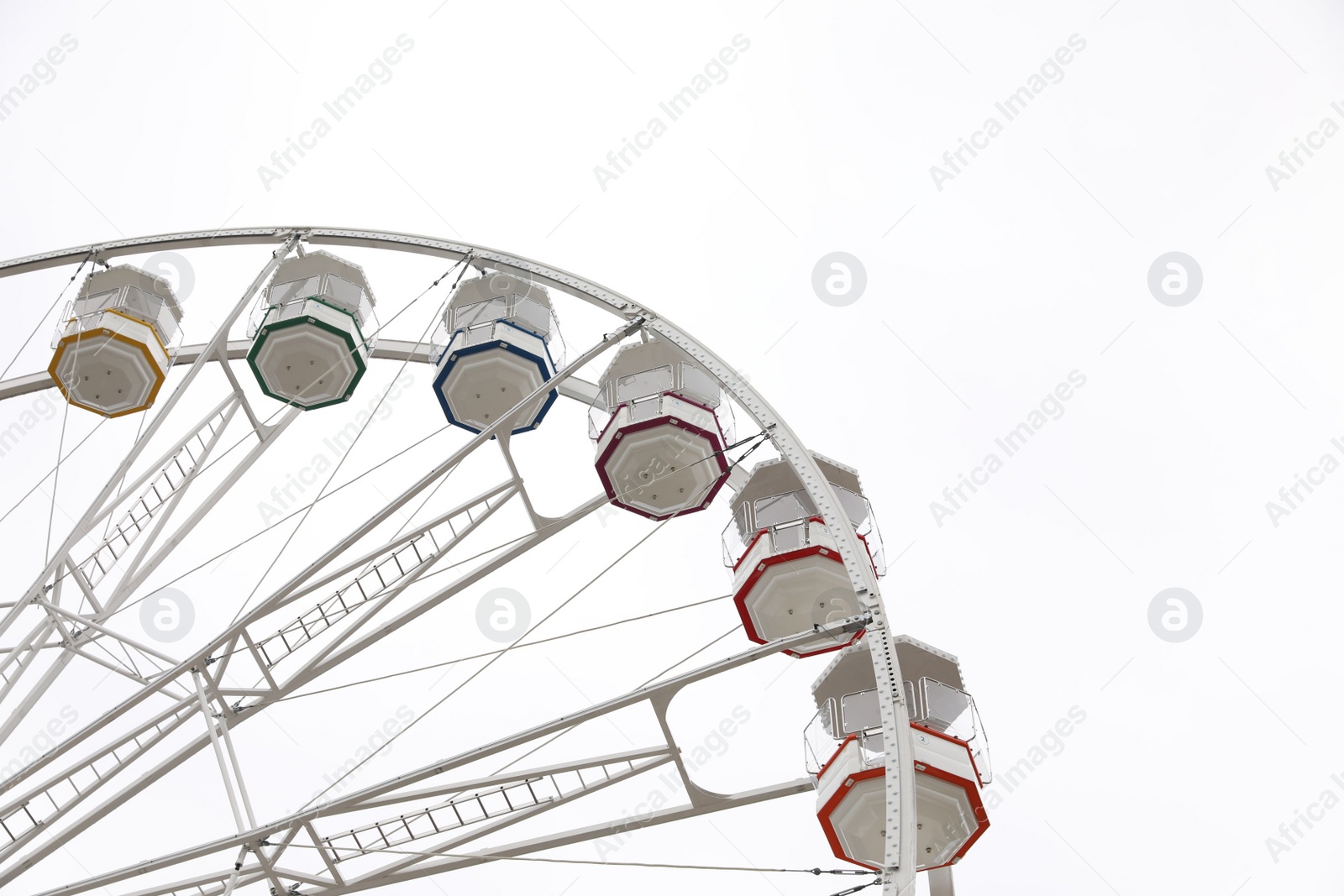 Photo of Large white observation wheel against sky, low angle view. Space for text