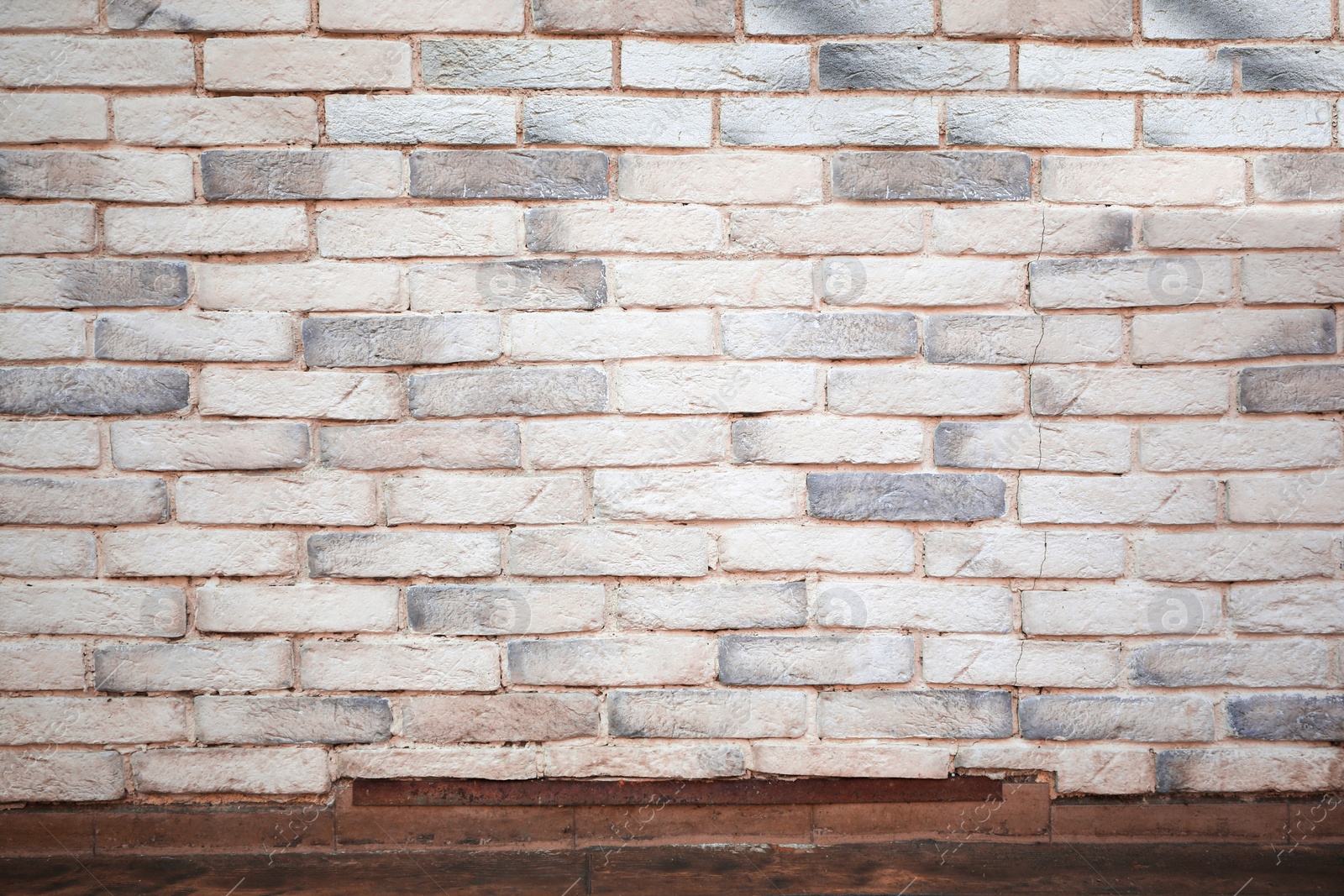 Photo of View on white brick wall and wooden floor