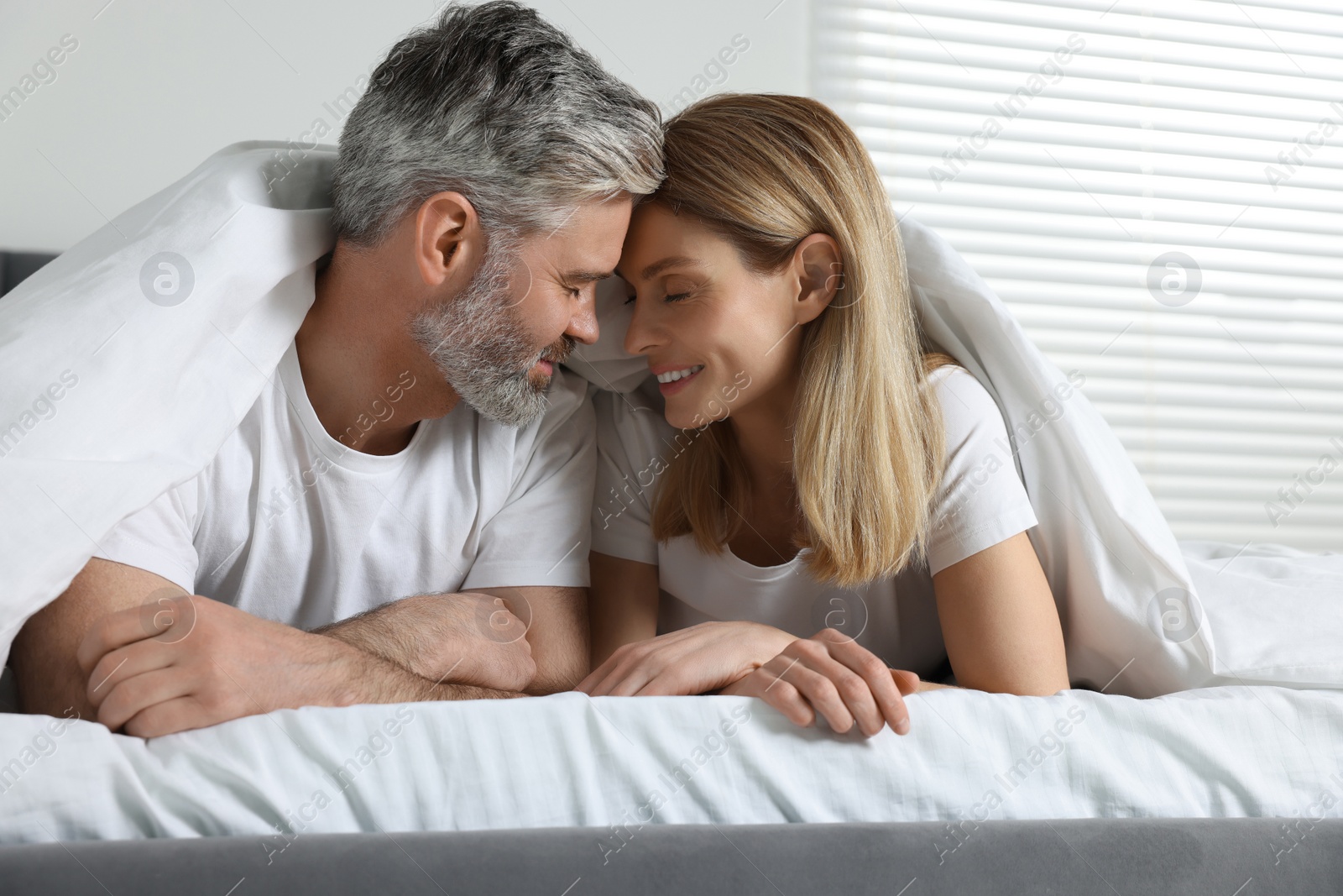 Photo of Lovely mature couple in bed at home