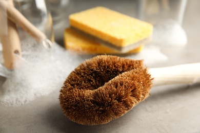 Cleaning brush for dish washing on grey table, closeup