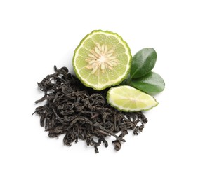 Photo of Pile of dry bergamot tea leaves and fresh fruit on white background, top view