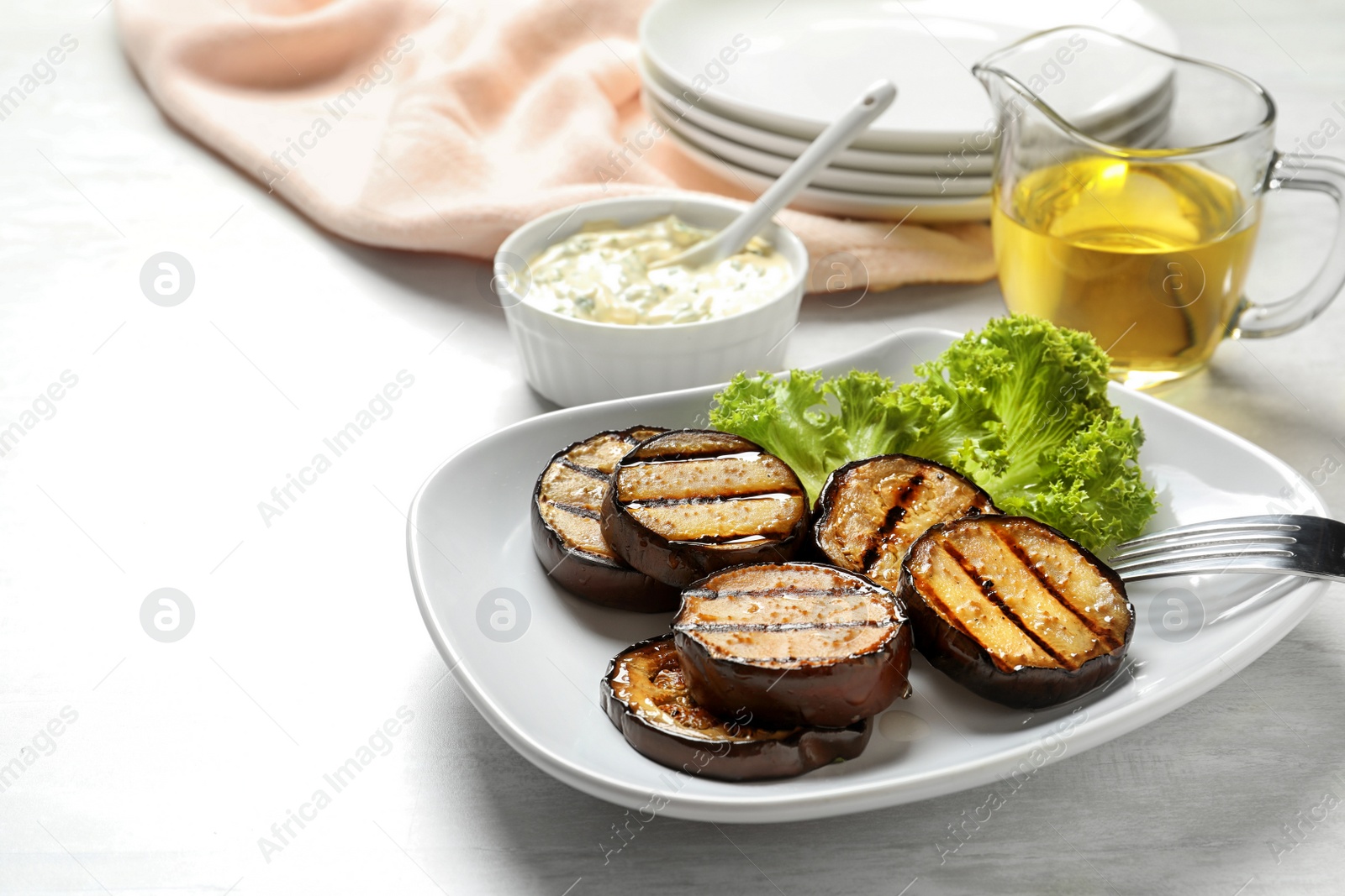 Photo of Plate with fried eggplant slices on table