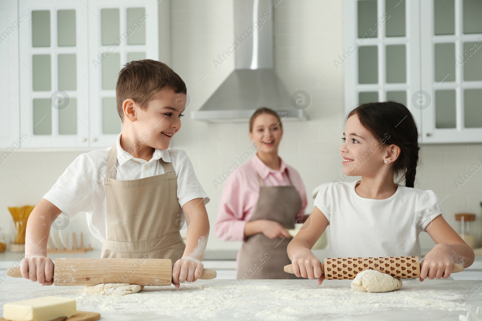 Photo of Happy family cooking together in kitchen at home