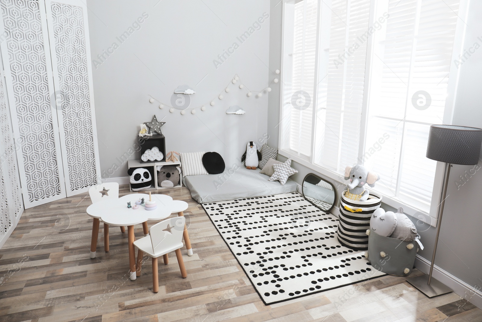 Photo of Montessori bedroom interior with floor bed and toys