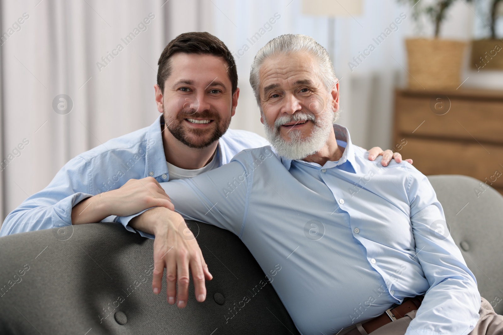 Photo of Happy son and his dad at home