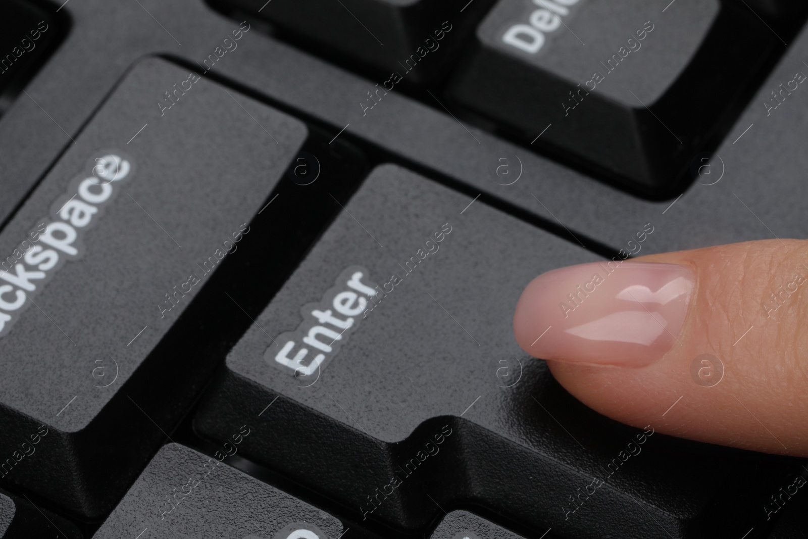 Photo of Woman pressing button on computer keyboard, closeup