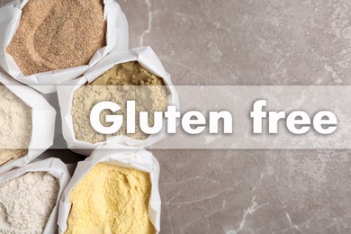 Image of Gluten free products. Bags with different types of flour on grey table and text, top view