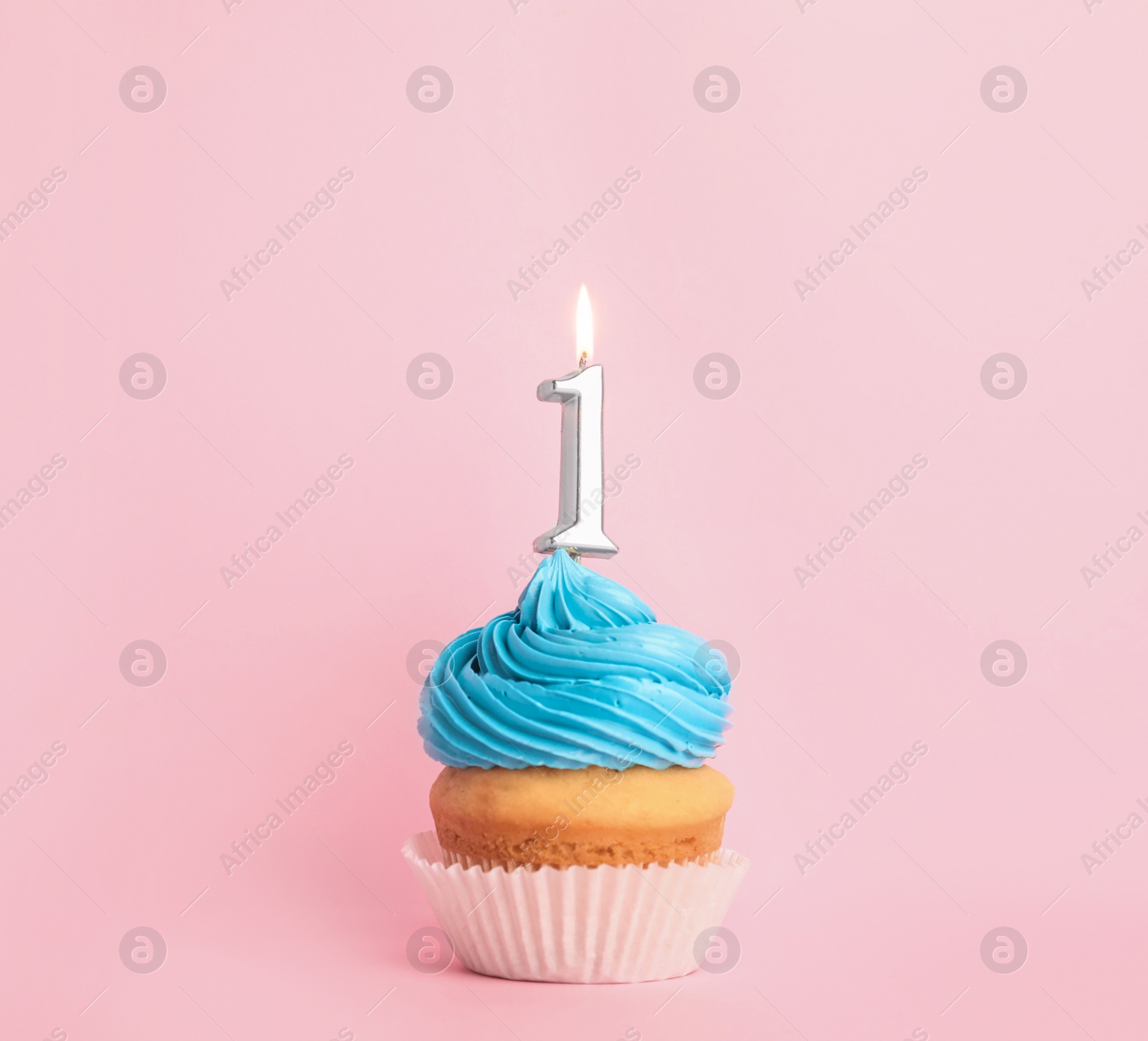 Photo of Birthday cupcake with number one candle on pink background