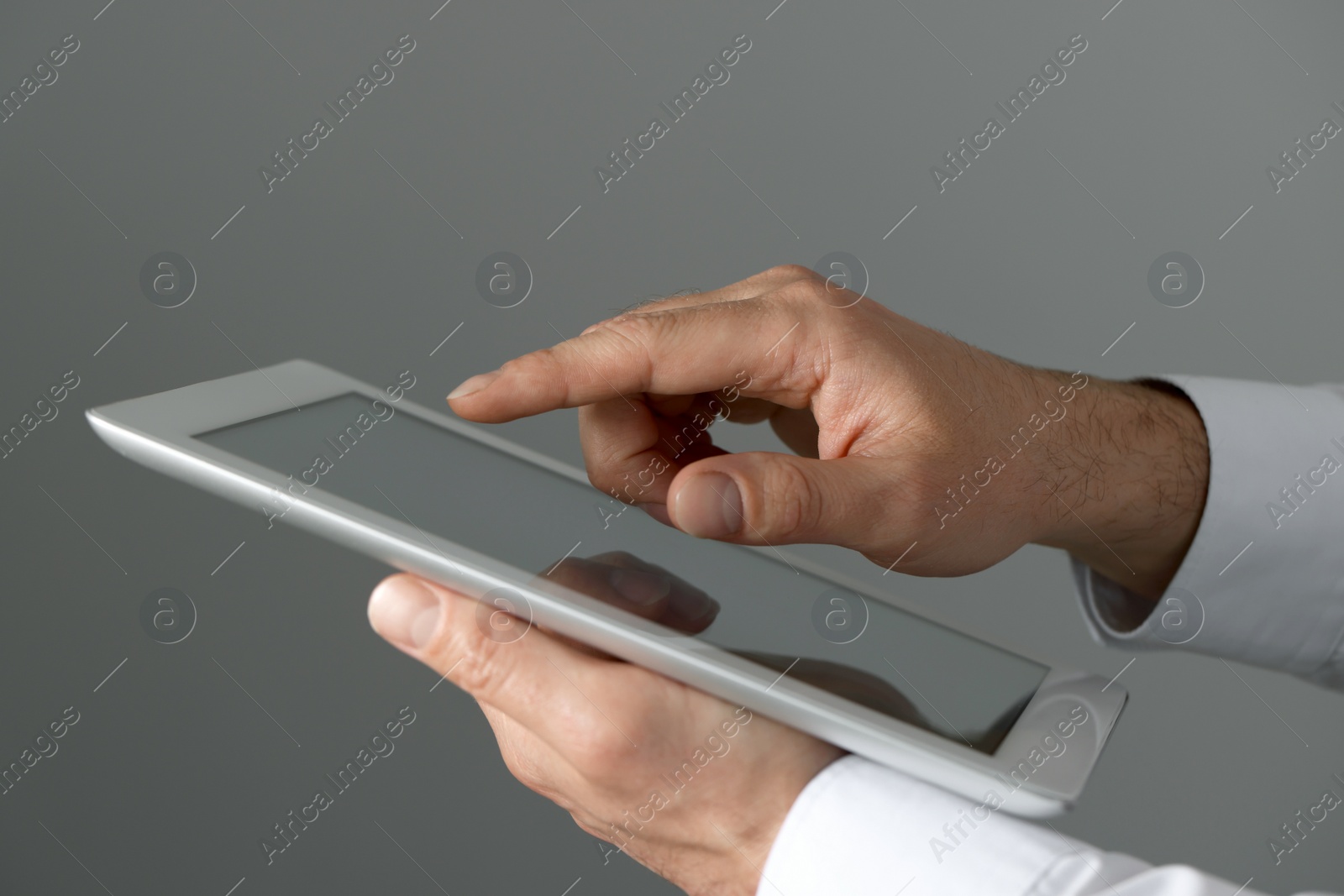 Photo of Closeup view of man using new tablet indoors