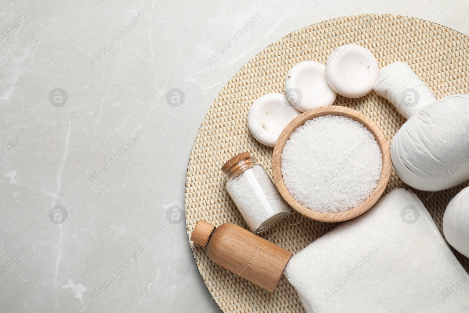 Photo of Flat lay composition with herbal bag and other spa products on light grey marble table. Space for text