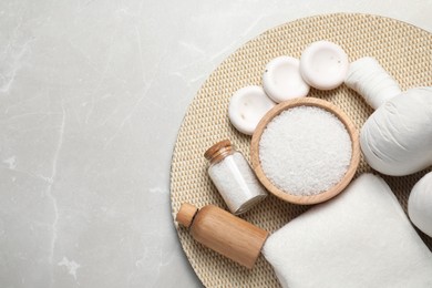 Flat lay composition with herbal bag and other spa products on light grey marble table. Space for text