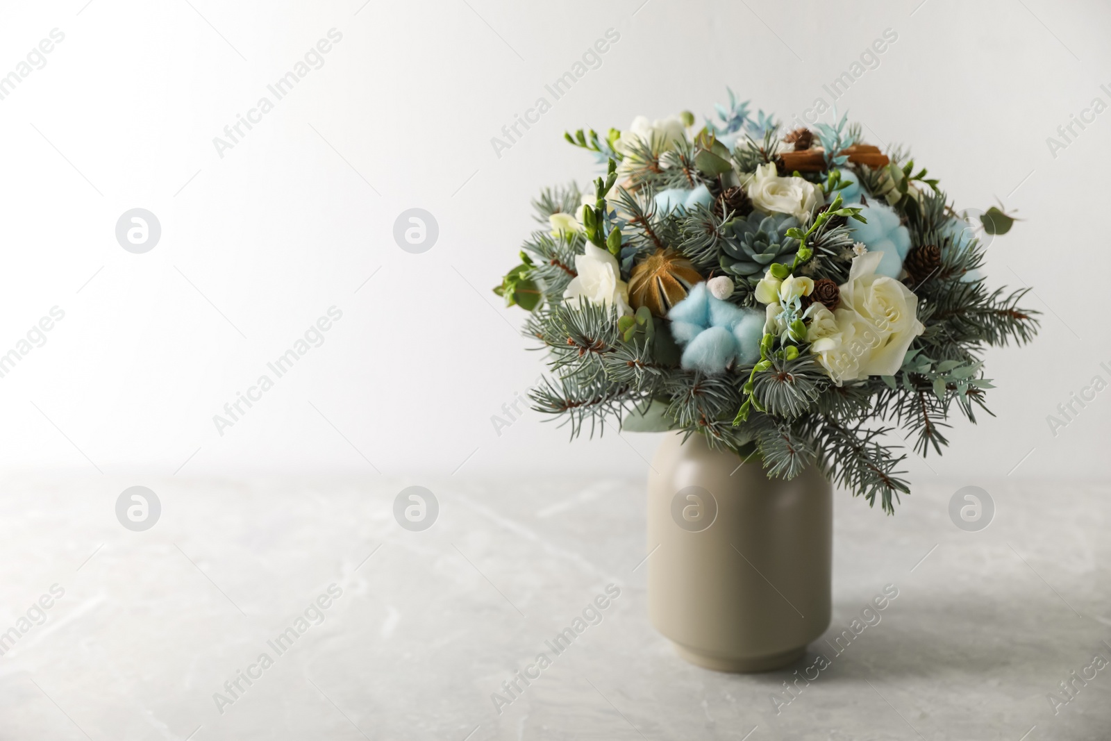 Photo of Beautiful wedding winter bouquet on grey table. Space for text