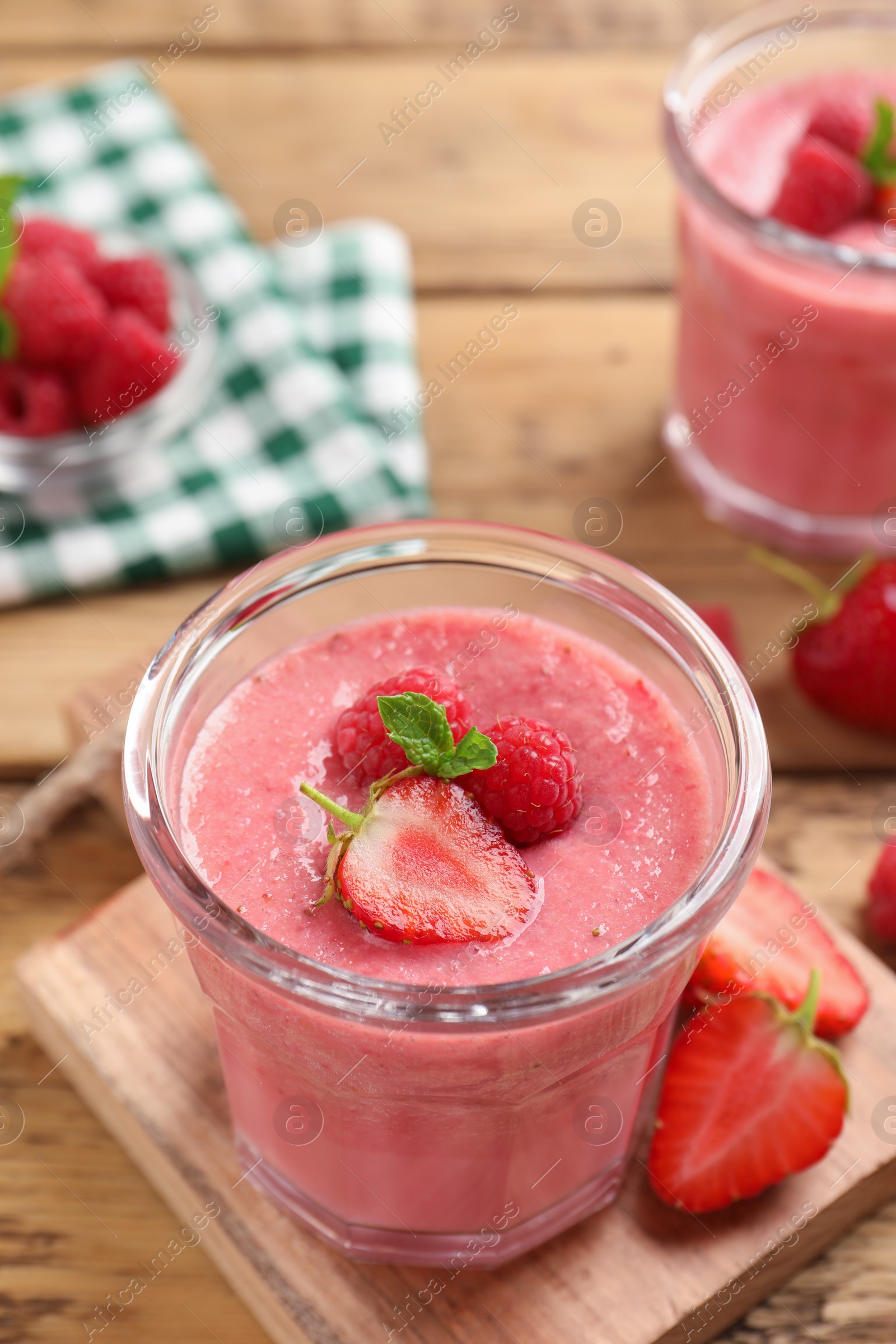 Photo of Delicious berry mousse with mint on wooden table