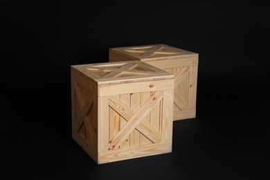 Photo of Pair of wooden crates on black background