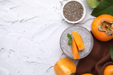 Photo of Delicious dessert with persimmon and chia seeds on table, flat lay. Space for text