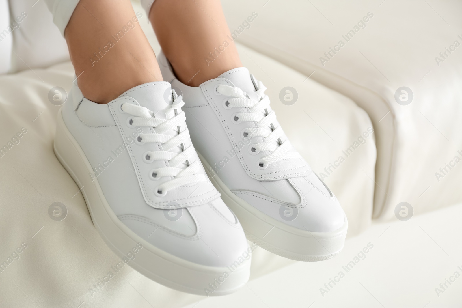 Photo of Woman wearing comfortable stylish shoes indoors, closeup