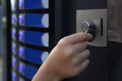 Photo of Using coffee vending machine. Girl inserting coin into acceptor, closeup