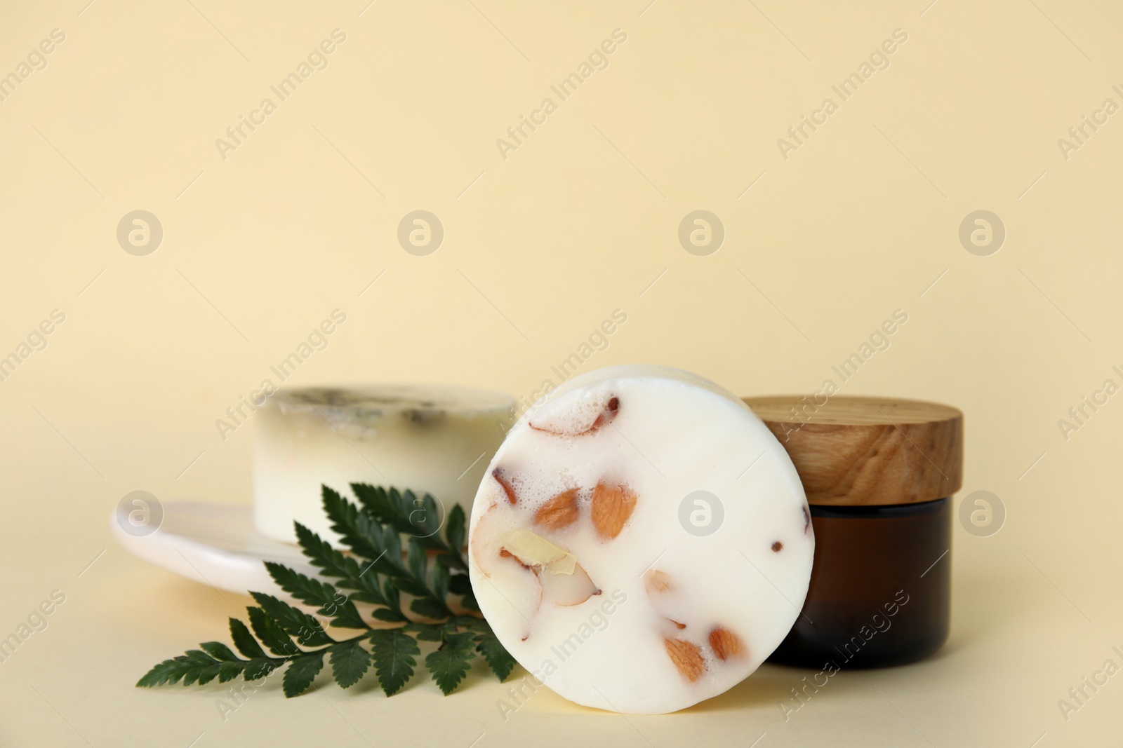 Photo of Eco friendly personal care products and green leaf on beige background