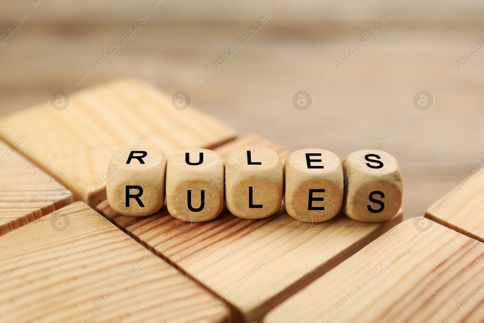 Photo of Word Rules made of cubes with letters on wooden blocks