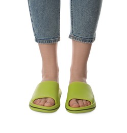 Woman in green slippers on white background, closeup