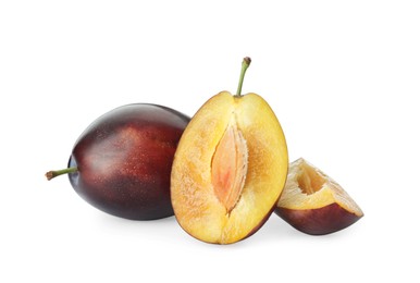 Photo of Whole and cut ripe plums on white background