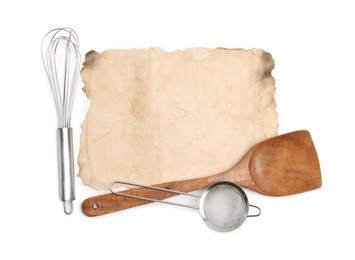 Old cookbook page and kitchen utensils on white background, top view. Space for text