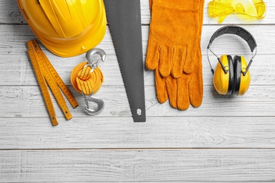 Photo of Flat lay composition with different construction tools on white wooden background