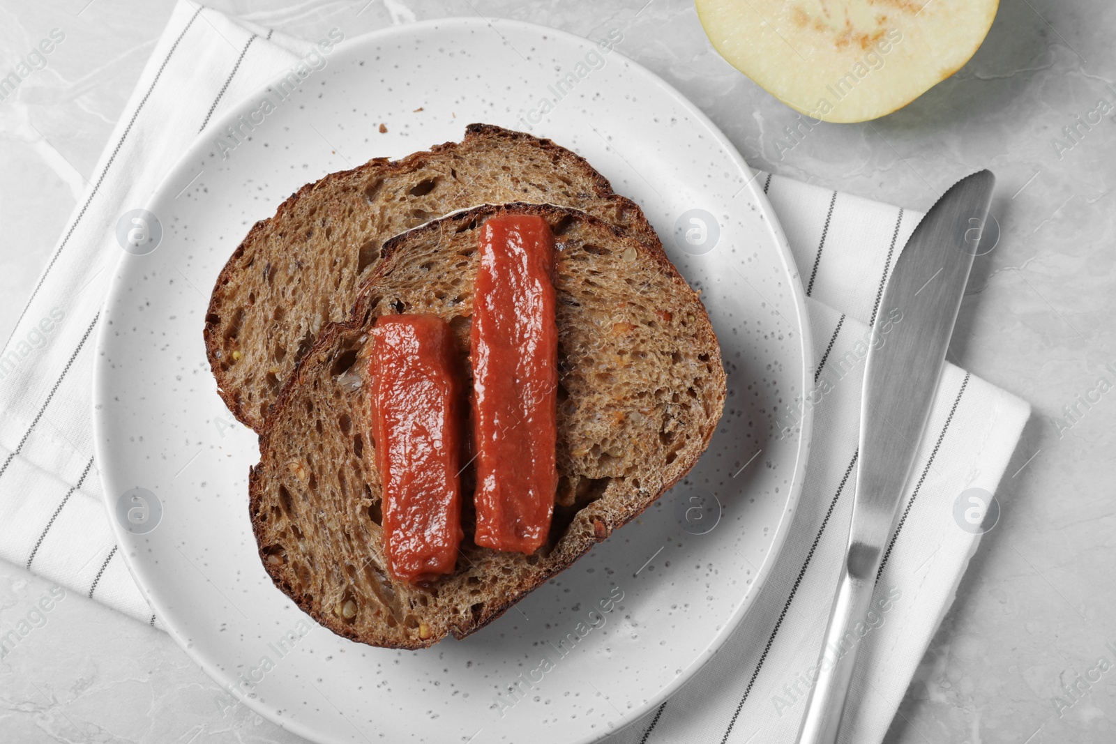 Photo of Sandwich with quince paste on light grey marble table, flat lay